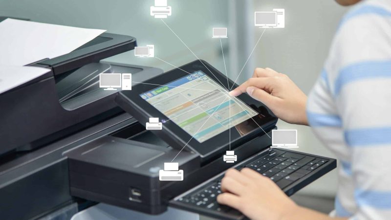 Business woman is using the printer to scanning document to network folder with icon of printer and computer